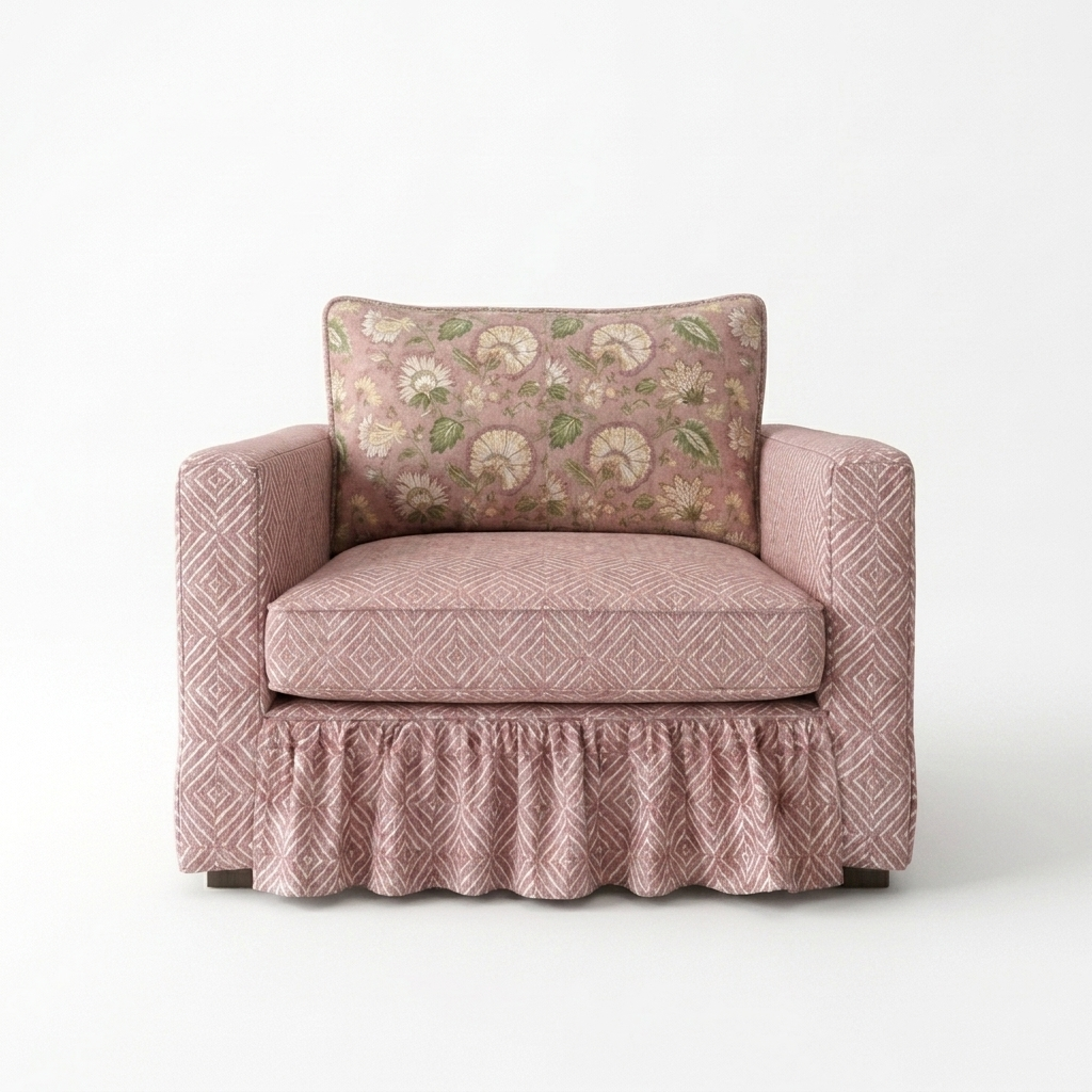 Pink armchair with a patterned cushion on a white background