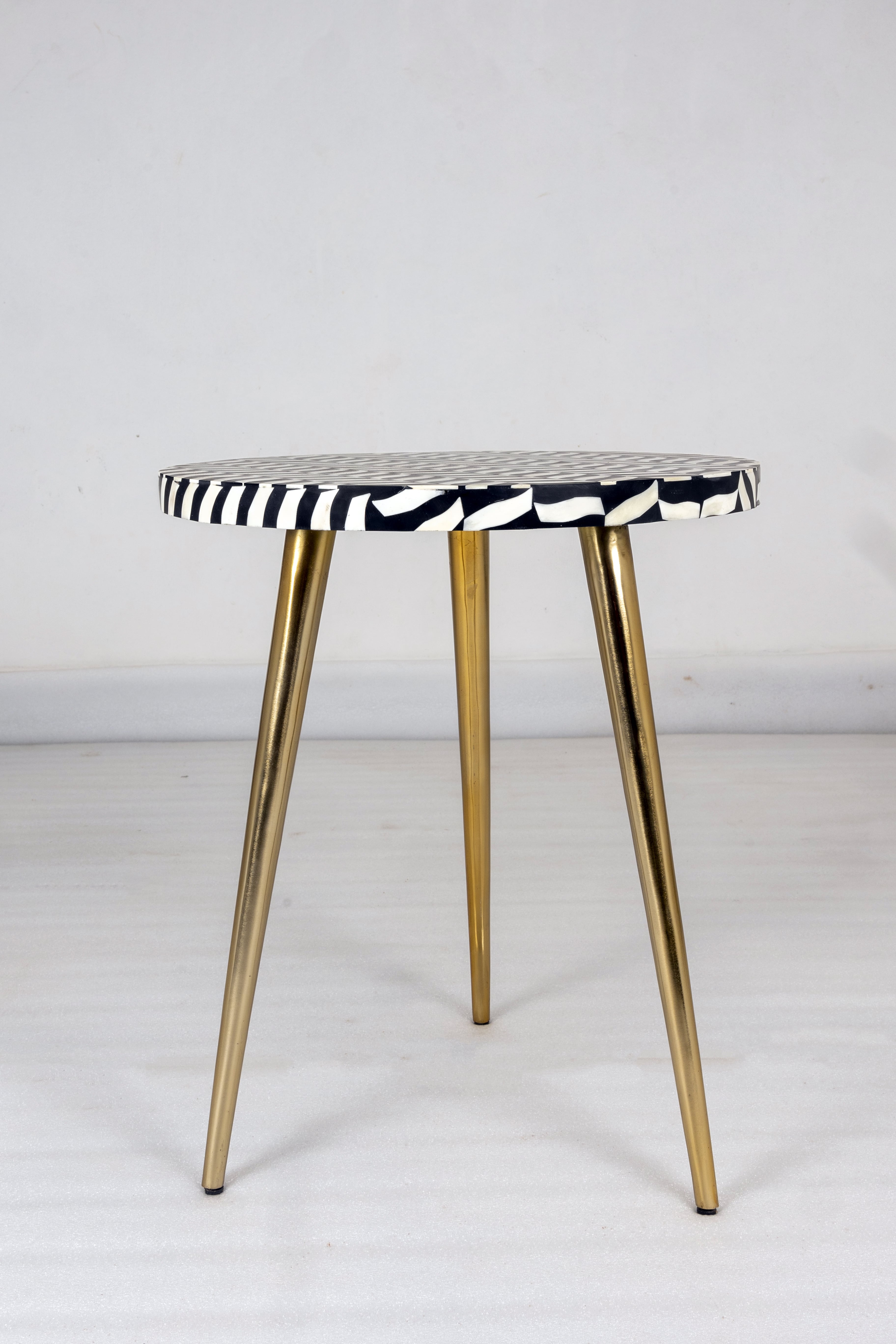 "Black round bone inlay side table supported by 3 sturdy legs"
