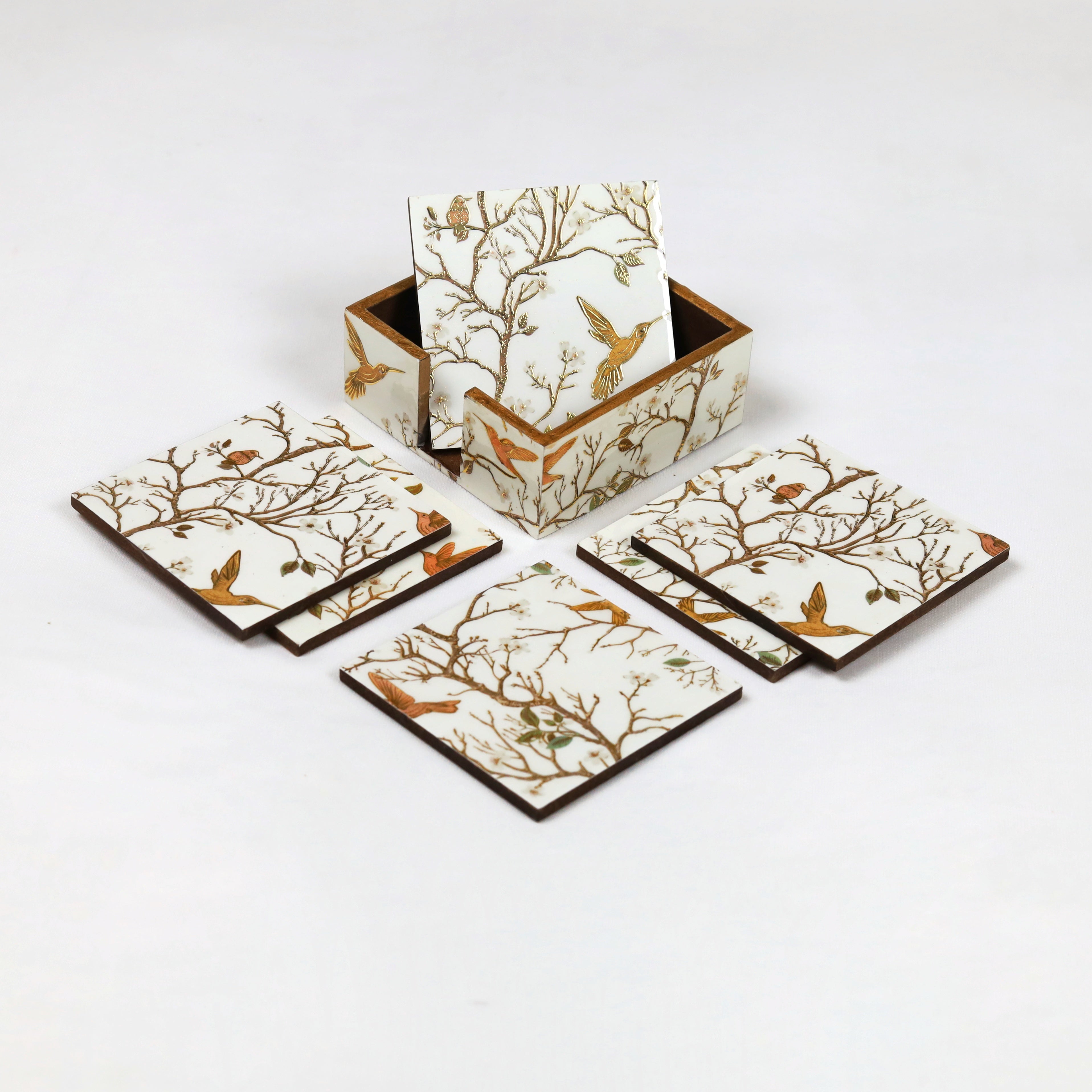 Coaster set with a gold-accented tissue box
