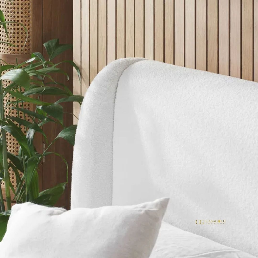 Boucle bed with an elegant, curved headboard
