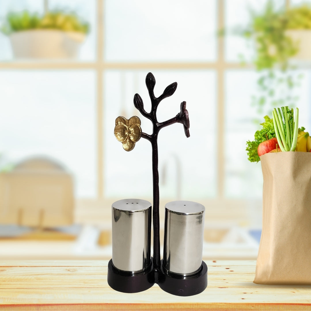 Steel salt and pepper shakers on a table