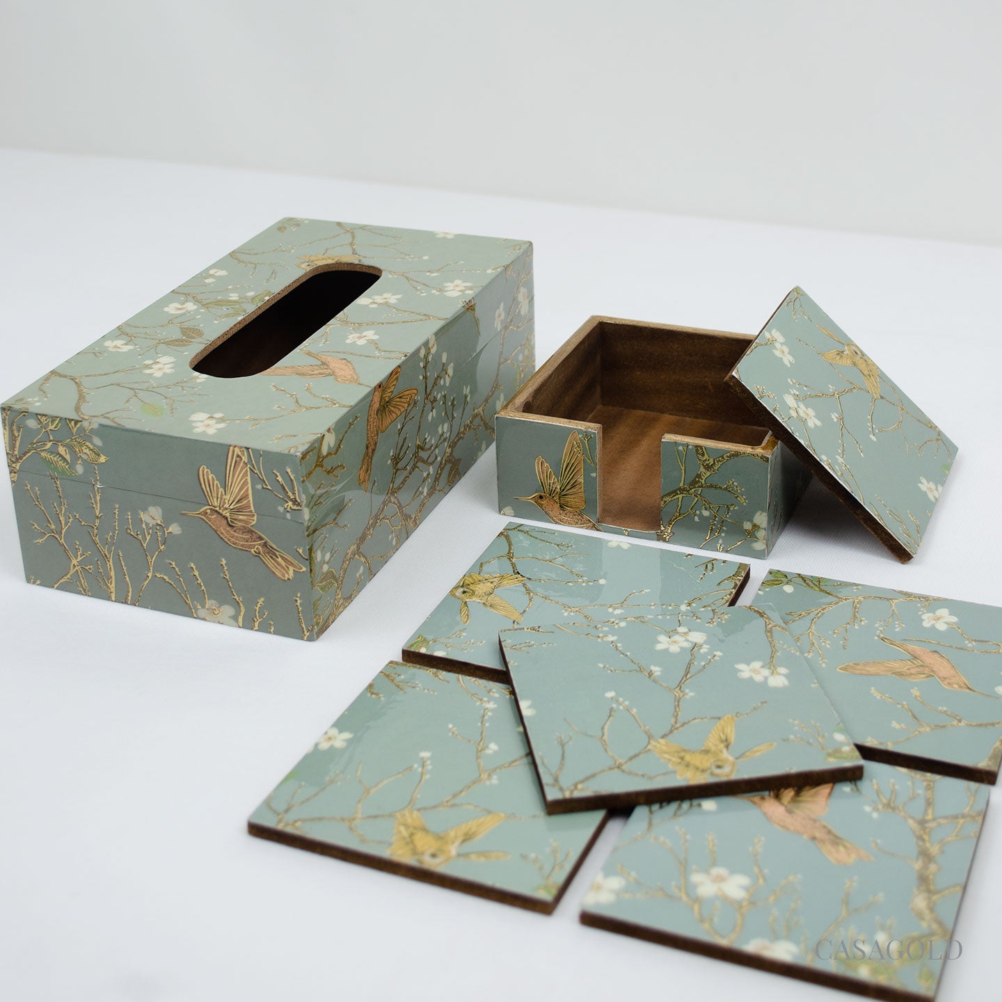 Coaster set with a gold-accented tissue box