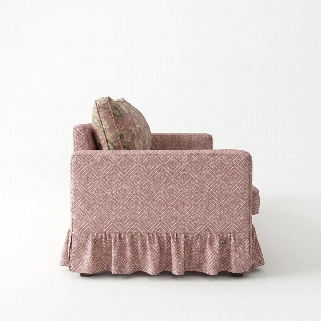 Pink patterned armchair with a decorative pillow on a white background