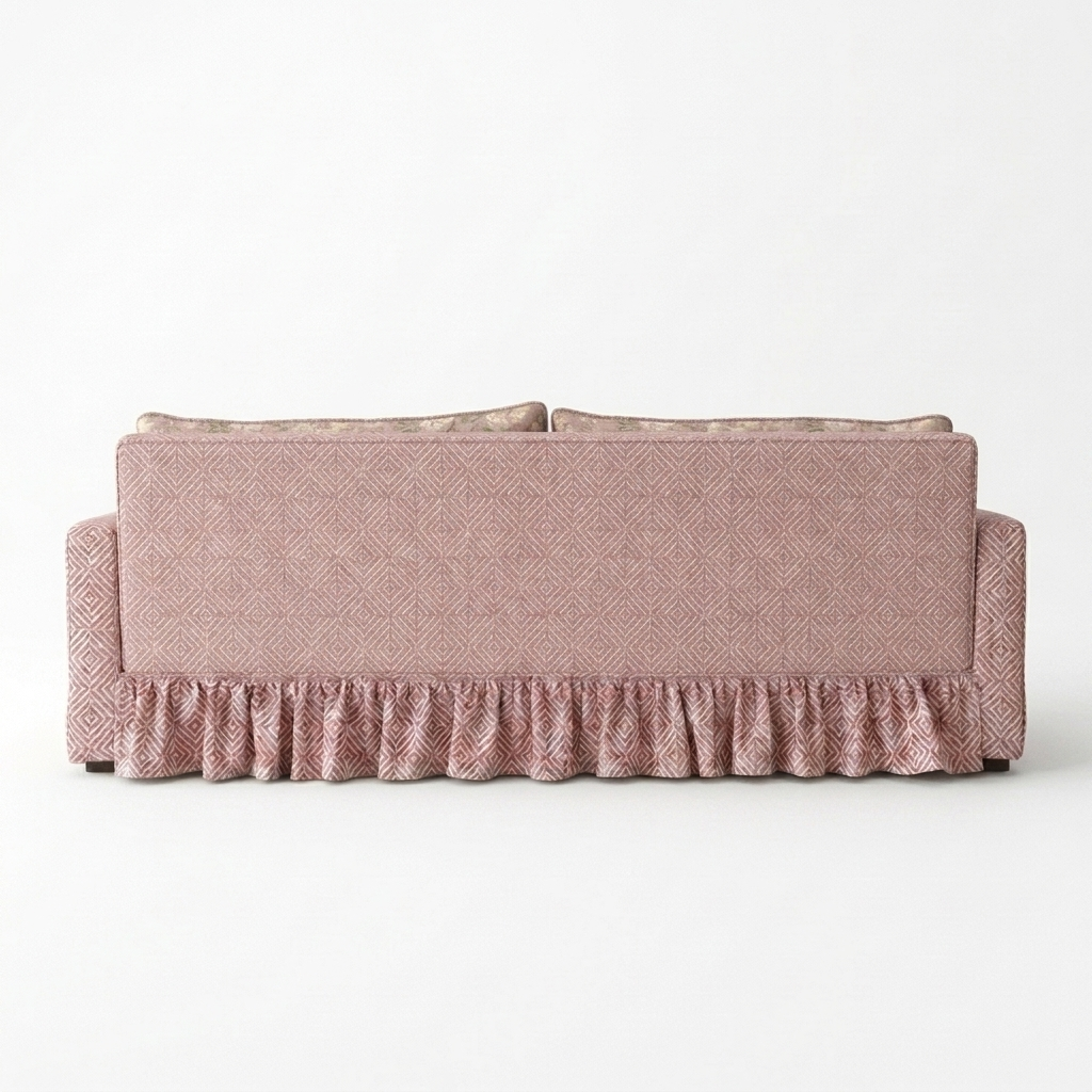 Pink textured sofa with ruffled bottom on a white background