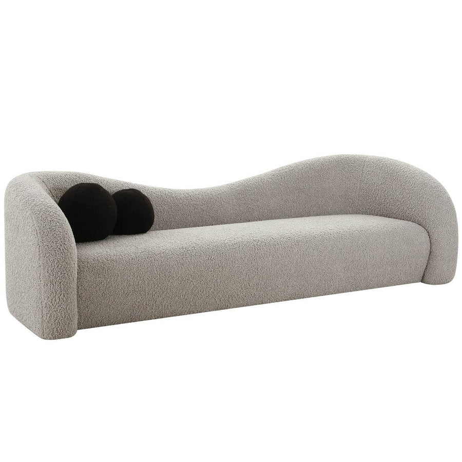 "Sculptural luxury sofa with brass legs and designer appeal"
