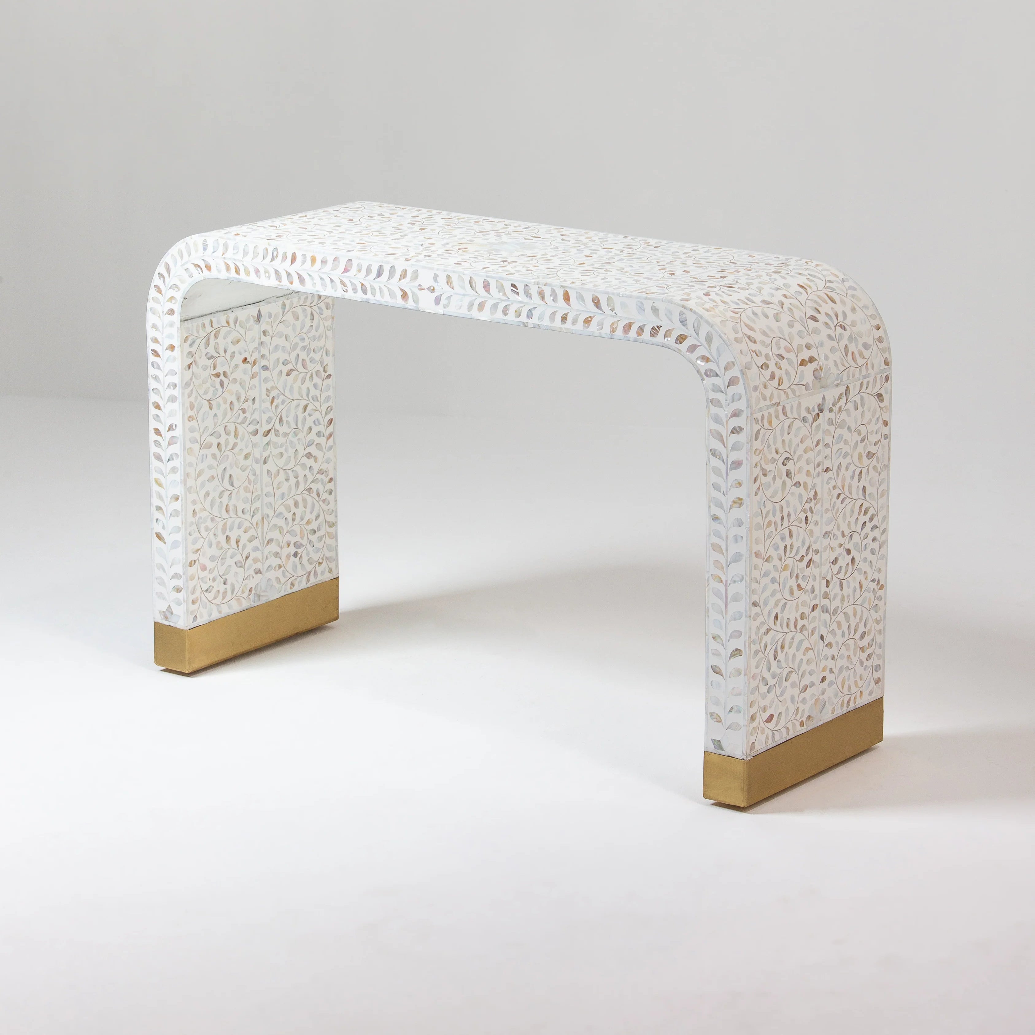 Decorative console table with mother of pearl cleo surface and gold base on bottom