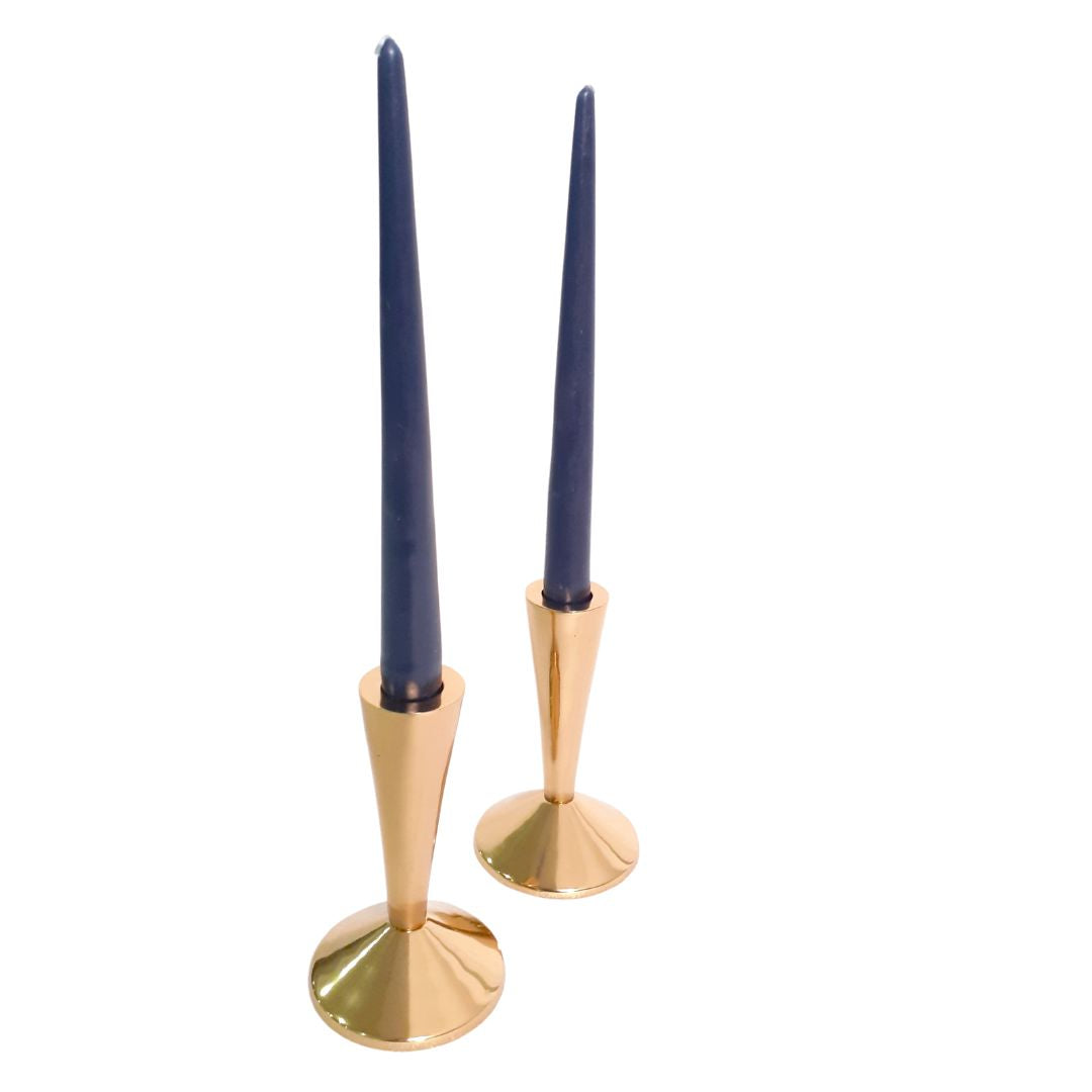 Intricate brass candle holder on a mantle