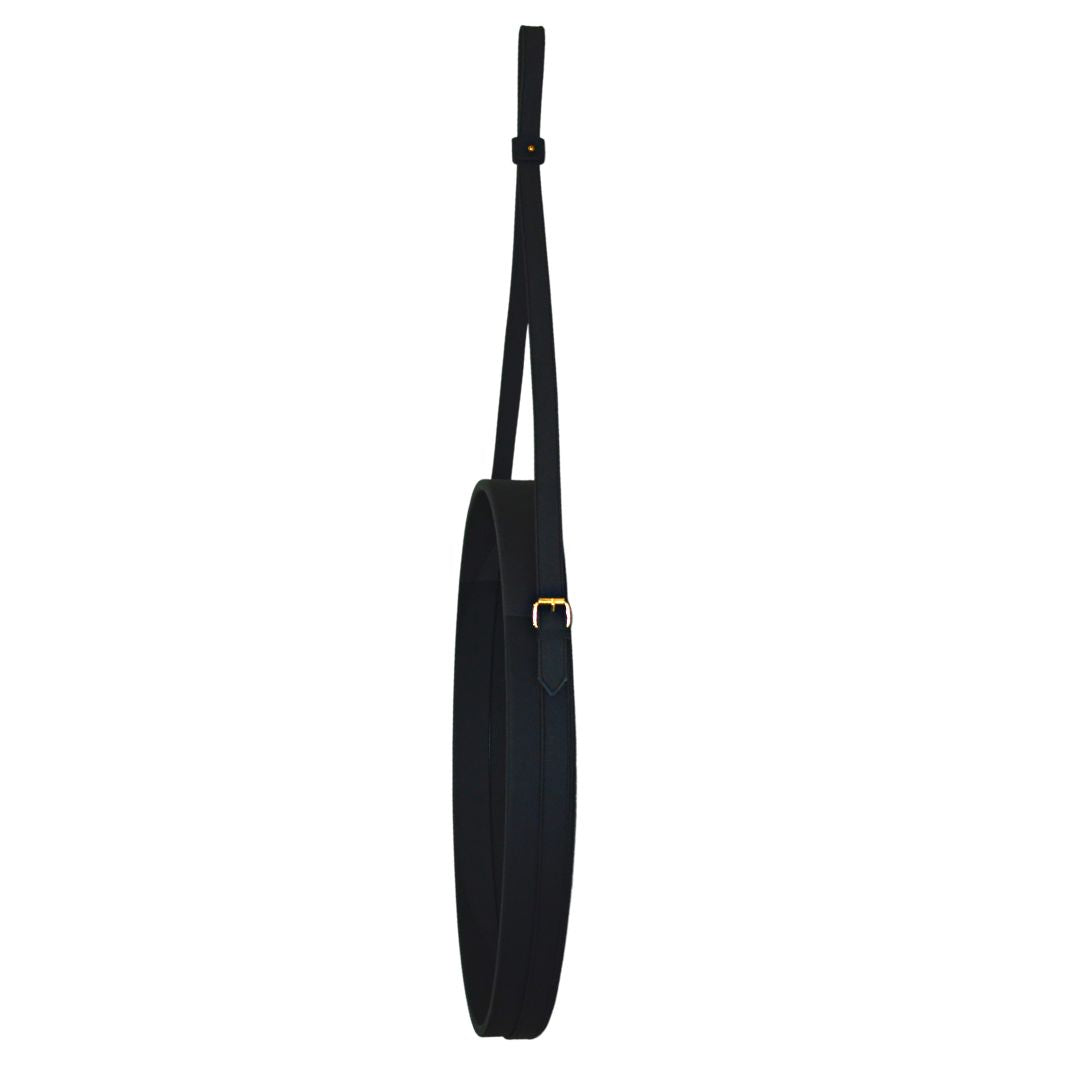 "Minimalist black leather mirror, perfect for sleek modern interiors."