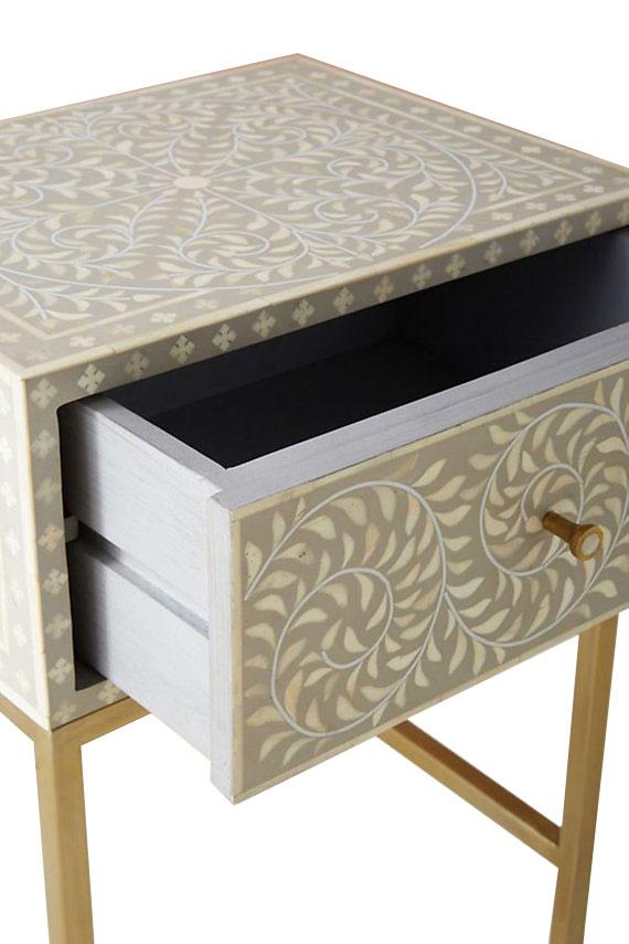 "Rectangular bone inlay bedside table with a sturdy rectangular gold frame for support"