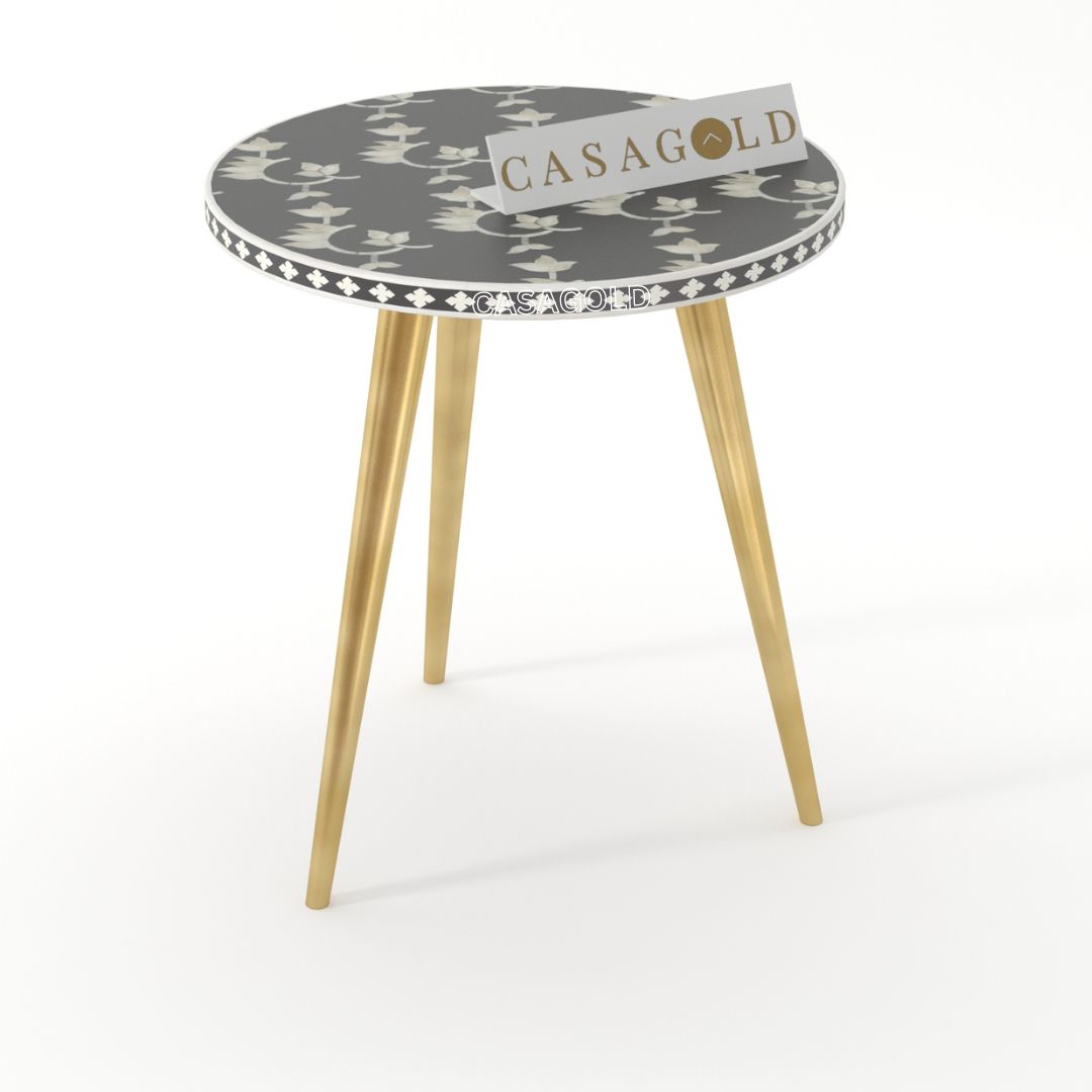 "Round inlay side table with overlay -inspired patterns and three legs"