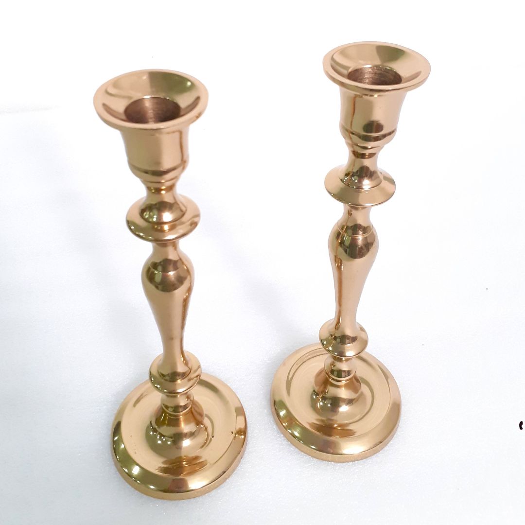 Votive brass holder with glowing candles