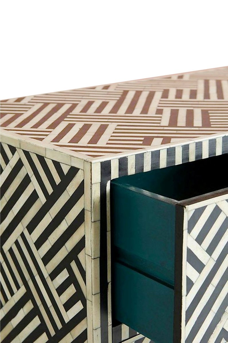 "White bone inlay bedside table with rectangular gold legs for a luxurious touch"