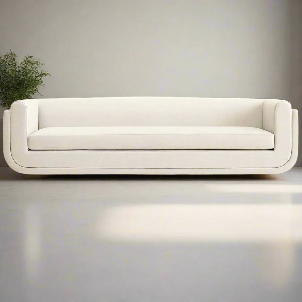 Minimalist white sofa with curved arms and low profile