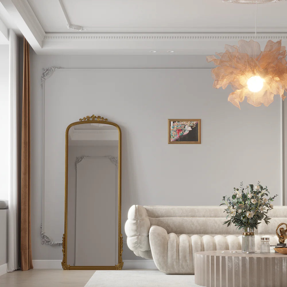 Elegant Casagold full-length mirror with a gold ornate frame in a modern living room, enhancing style and space with a luxurious touch.