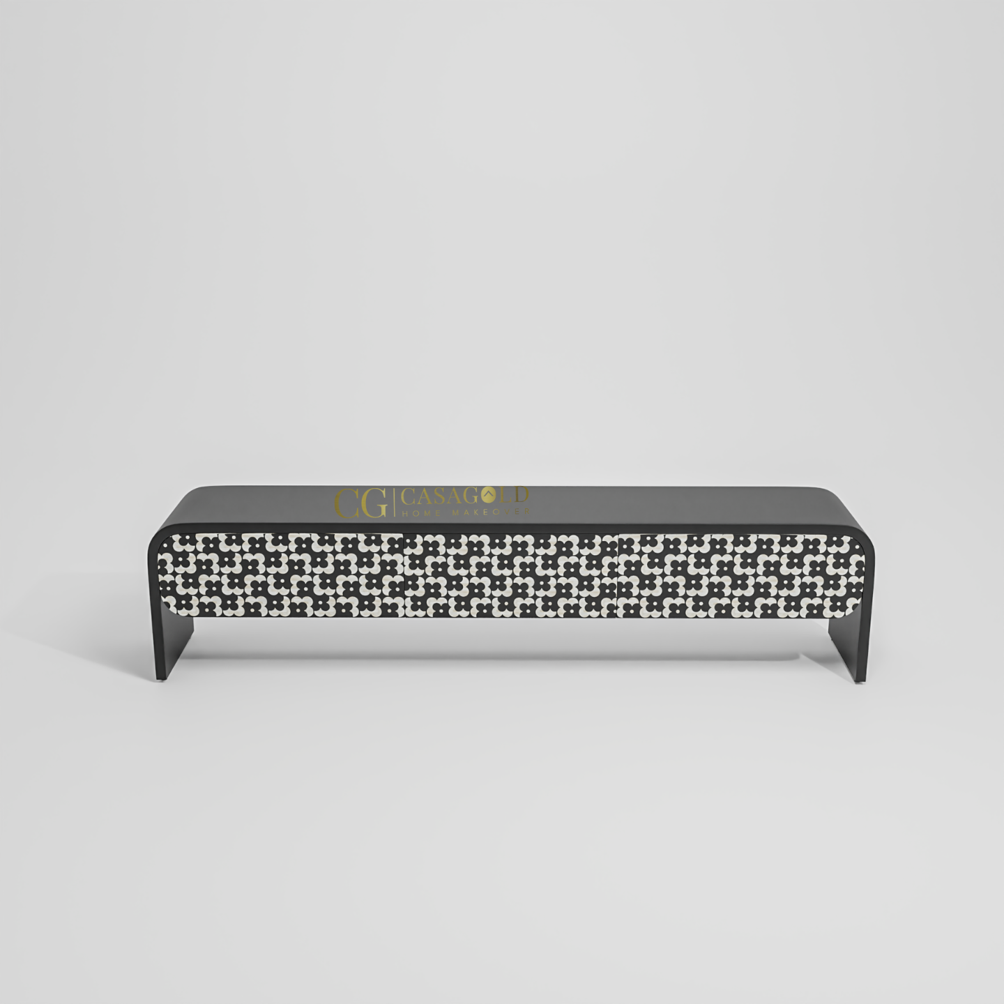 A contemporary TV console or media unit, showcasing a striking black and white tile-like pattern on its front. 
