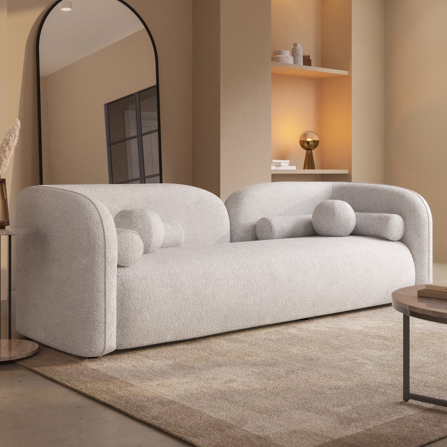 Luxury cream bouclé curved sofa with artistic silhouette and plush cushions, perfect for modern living rooms