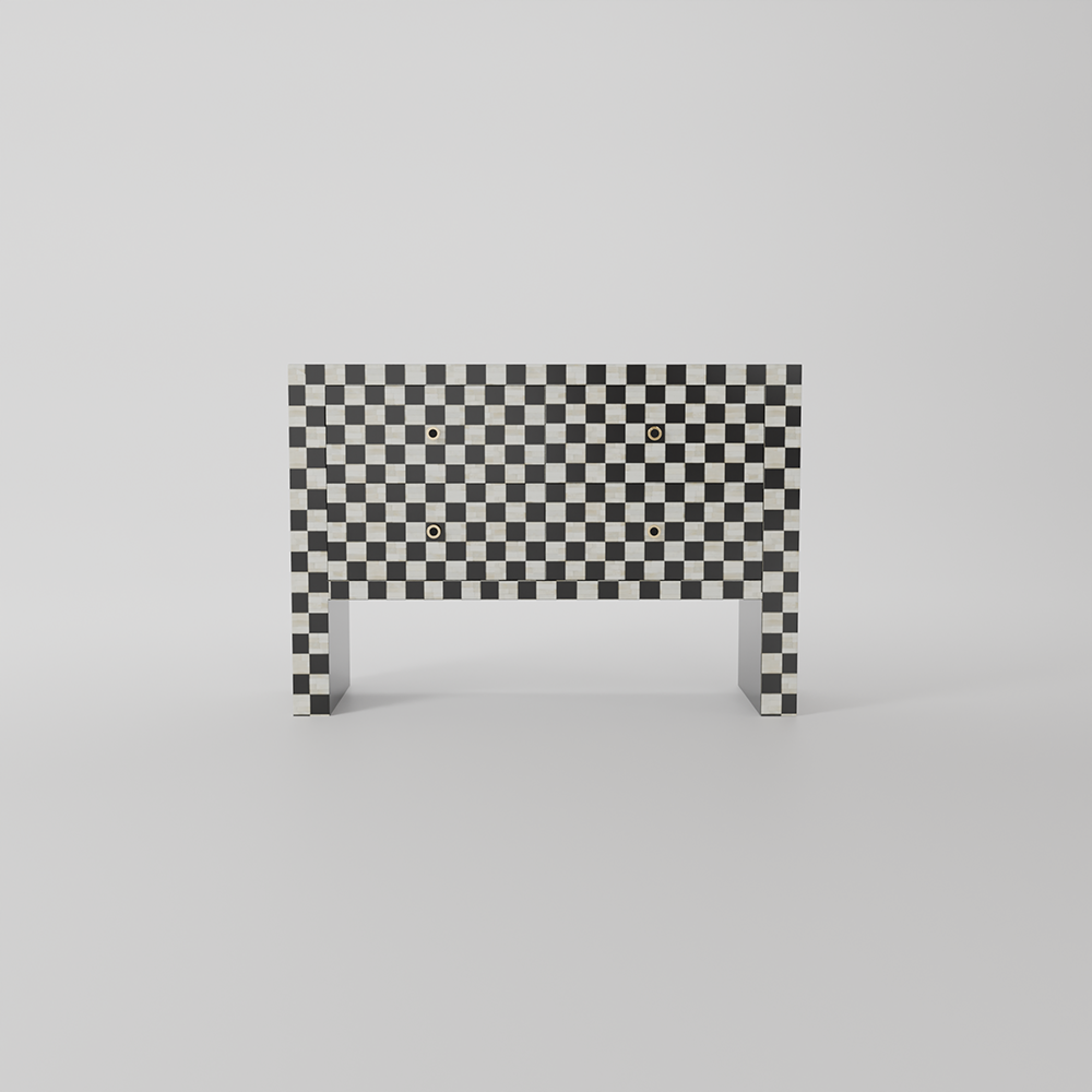 A modern console table featuring a black and white checkerboard pattern on its rectangular backrest and legs, with small gold square details on the front, set against a seamless light gray background.