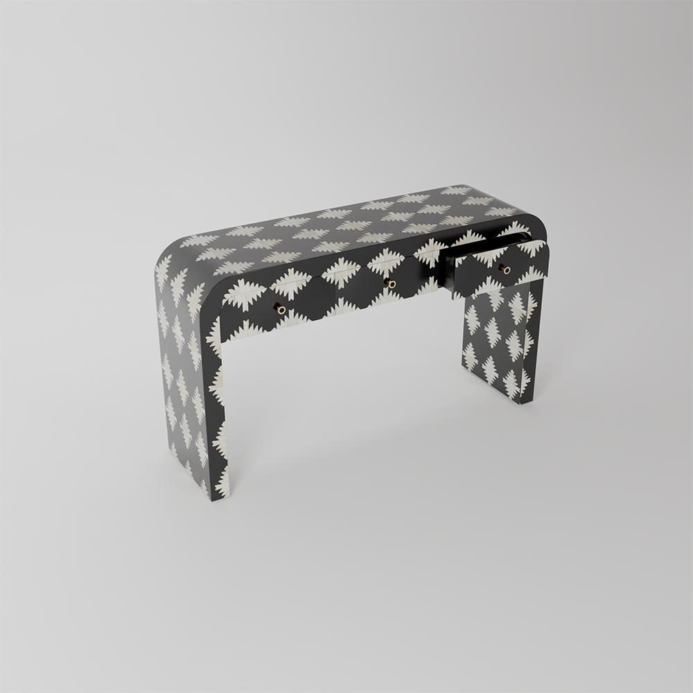 A modern console table with a black and white geometric pattern, featuring a single drawer with a black handle, photographed on a neutral light gray background.