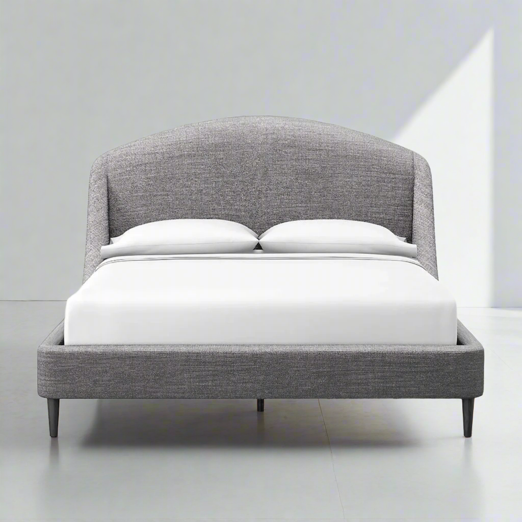 Modern gray upholstered bed with curved headboard.
