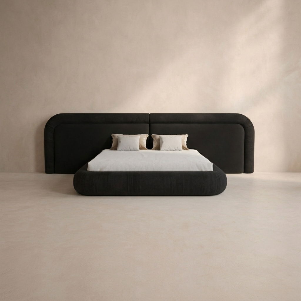 A modern platform bed with a tall, rounded headboard upholstered in black fabric, styled with white bedding and two beige accent pillows, set against a minimalist beige wall and floor.
