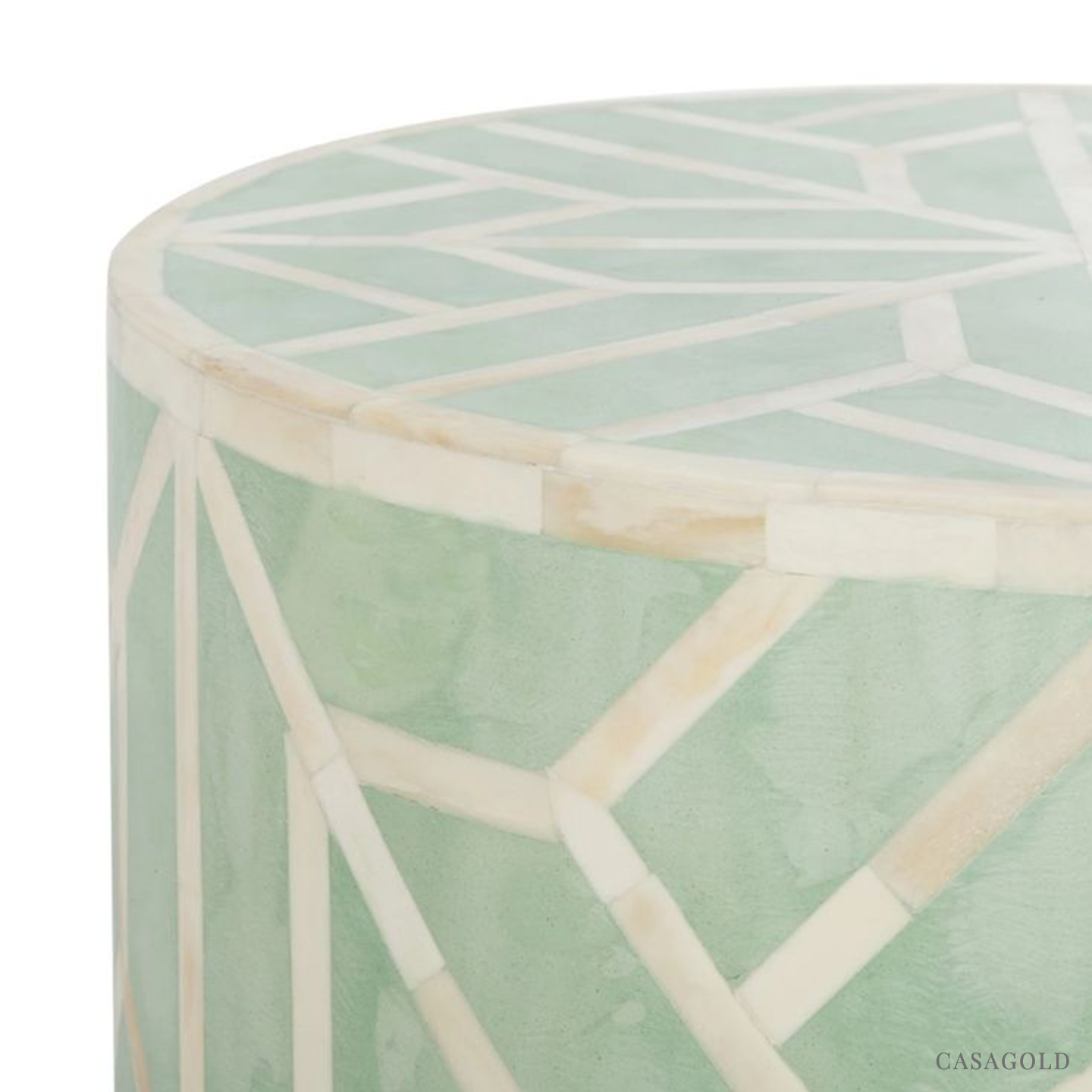 "Teal and white drum-shaped side table with bold inlay designs"