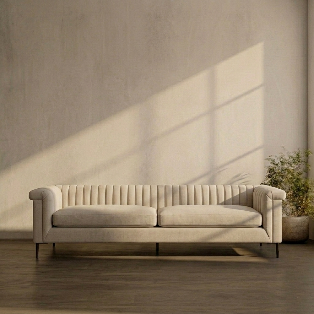Beige sofa in a room with a textured wall and plant