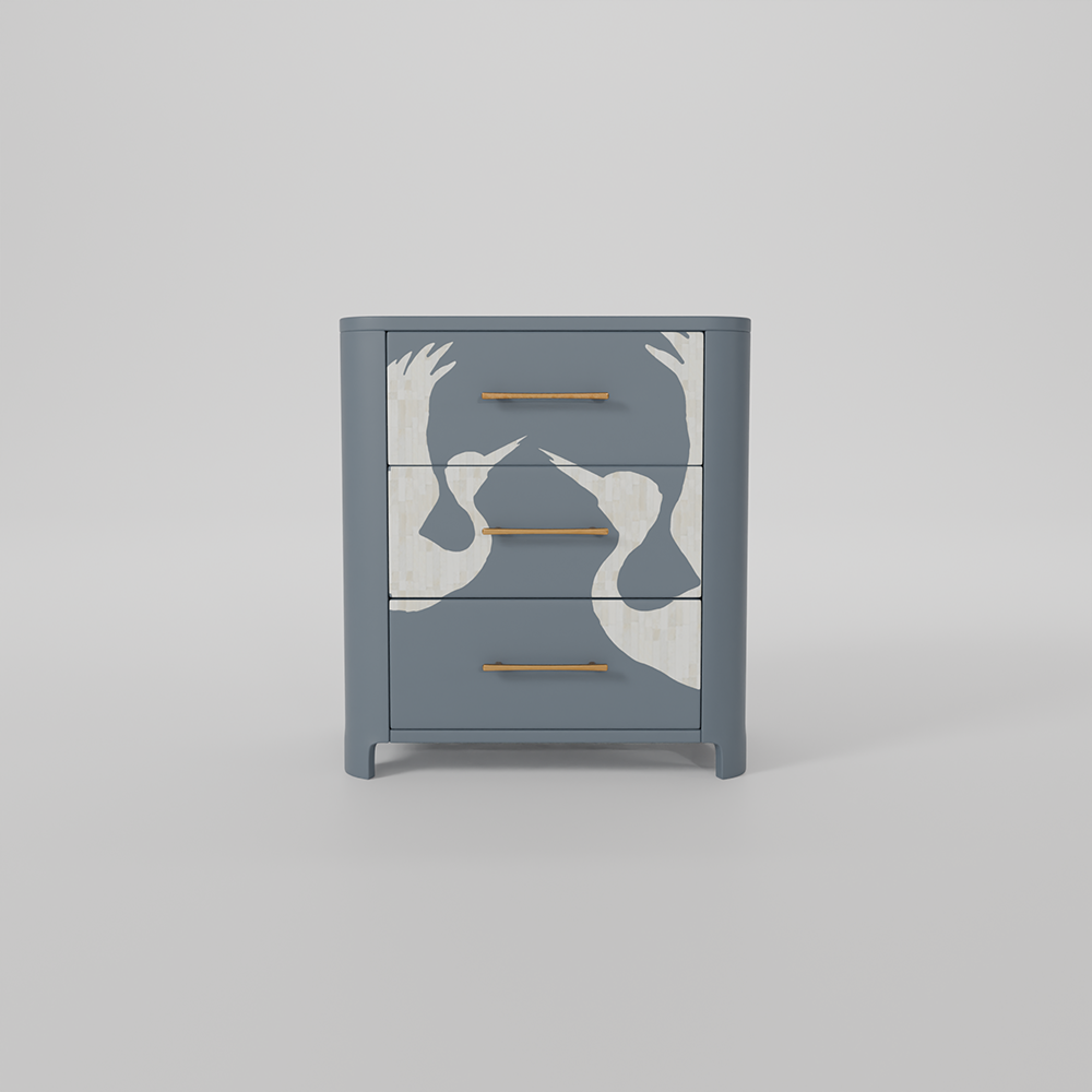 A three-drawer nightstand in a muted slate blue-gray finish, featuring a white hand-painted abstract design of two birds and two hands on the front, with slim gold metal handles.