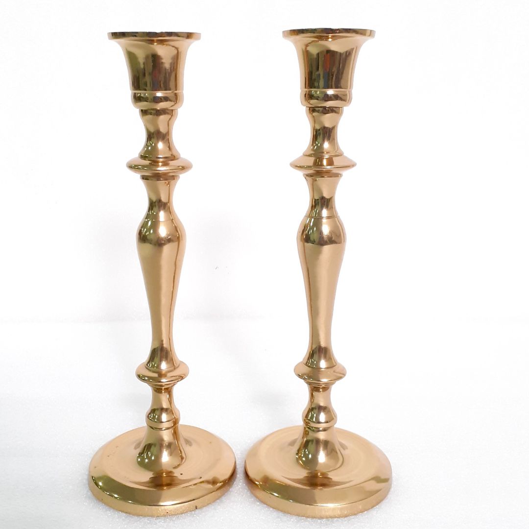 Brass holder with leaf design on a side table
