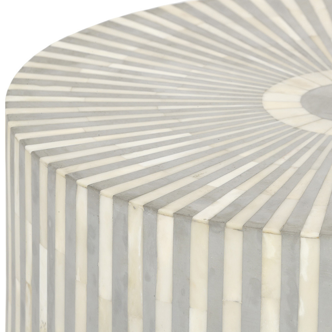 "Intricate drum inlay side table with artistic bone patterns"
